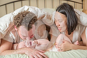 Mixed Race Chinese and Caucasian Baby Boy Laying In Bed with His