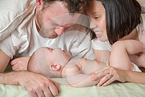 Mixed Race Chinese and Caucasian Baby Boy Laying In Bed with His