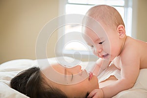 Mixed Race Chinese and Caucasian Baby Boy Laying In Bed with His