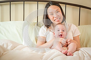 Mixed Race Chinese and Caucasian Baby Boy Laying In Bed with His