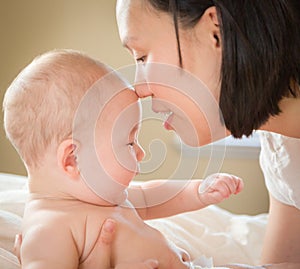 Mixed Race Chinese and Caucasian Baby Boy Laying In Bed with His