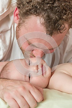 Mixed Race Chinese and Caucasian Baby Boy Laying In Bed with His Parents