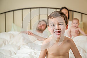 Mixed Race Chinese and Caucasian Boy Laying In Bed with His Family