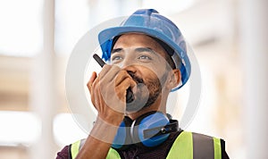 Mixed race construction worker using walkie on construction site