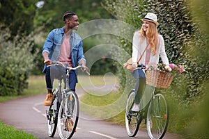 mixed-race couple cycling along cycle track