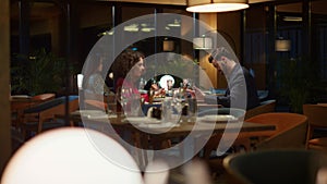 Mixed race couple eating enjoying restaurant food meal on night dinner date.