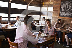 Mixed race couple enjoying lunch in a busy restaurant