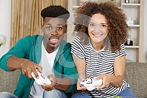 mixed race couple playing computer game