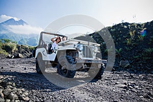Mixed race couple riding a jeep off road