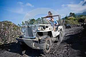 Mixed race couple riding a jeep off road