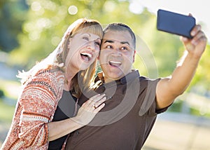 Mixed Race Couple Taking Selfie Portrait with a Smartphone