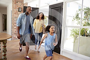 Mixed race couple and their daughter arriving home