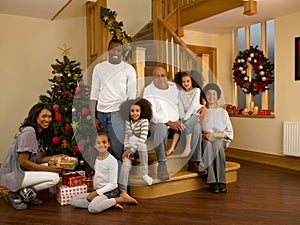 Mixed race family with Christmas tree and gifts