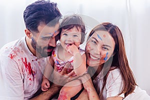 Mixed race family concept. Happy family playing multi color by put to their faces and body with smile and laughing together.