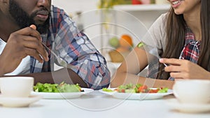 Mixed-race family couple communicating during lunch, pleasure pastime together