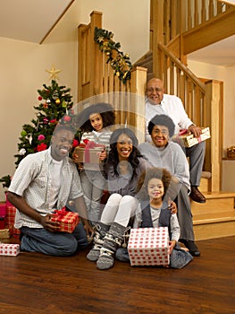 Mixed race family exchanging gifts at christmas