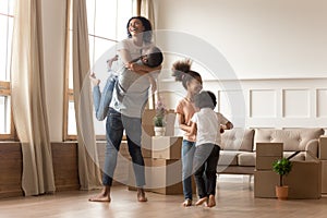 Mixed-race family fooling around having fun celebrating relocation day