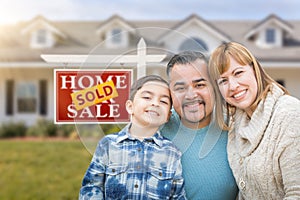 Mixed Race Family In Front of House and Sold For Sale Real Estate Sign