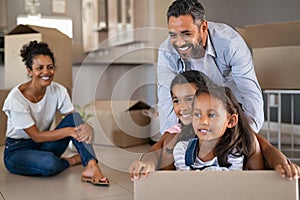 Mixed race family with kids enjoying moving in new house