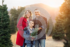 Mixed Race Family Outdoors At Christmas Tree Farm