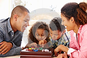 Mixed race family playing solitaire