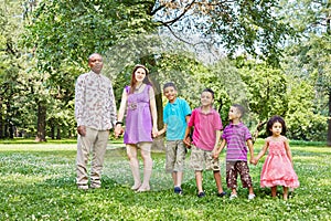 Mixed race family of six stands according to photo