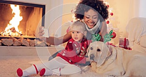 Mixed race family taking christmas selfie