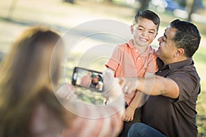 Mixed Race Family Taking Pictures with a Smart Phone Camera