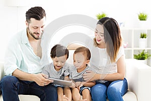 mixed race family watching the tablet photo