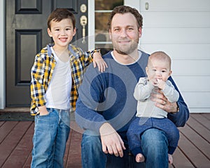 Mixed Race Father and His Two Sons on Front Porch