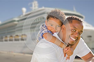 Mixed Race Father and Son In Front of Cruise Ship