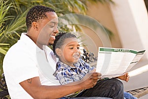 Mixed Race Father and Son Reading Park Brochure