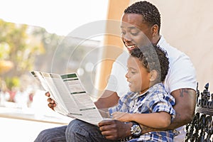 Mixed Race Father and Son Reading Park Brochure