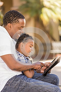 Mixed Race Father and Son Using Touch Pad Computer