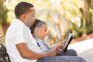 Mixed Race Father and Son Using Touch Pad Computer Tablet