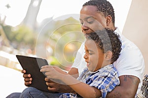 Mixed Race Father and Son Using Touch Pad Tablet