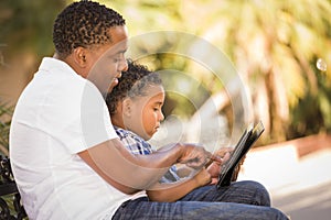 Mixed Race Father and Son Using Touch Pad Tablet