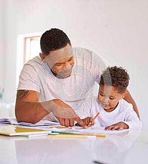 Mixed race father teaching little son during homeschool class at home. Cute little hispanic boy learning how to read and