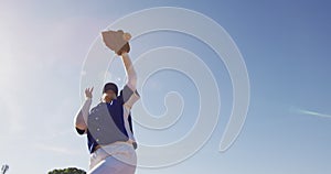 Mixed race female baseball fielder catching and dropping ball on sunny baseball field