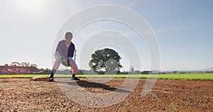 Mixed race female baseball fielder catching and throwing ball on sunny baseball field