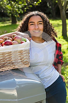 Mixed Race Female Teenager Leaning on Tractor Picking Apples