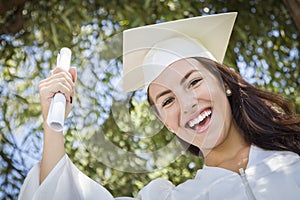 Mixed Race Girl In Cap and Gown Holding Diploma