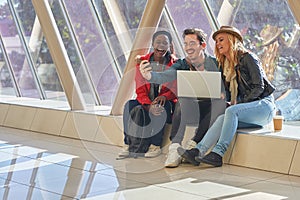 Mixed race group of students entrepeneurs taking selfies around