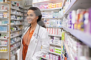 Mixed race happy pharmacist in medical shop