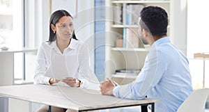 Mixed race hiring manger in interview with businessman. CEO with resume and cv of candidate looking for job opening