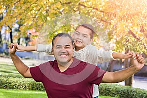 Mixed Race Hispanic and Caucasian Son and Father Having Fun At The Park