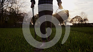 Mixed race male farmer walking through wheat fields with pitch fork