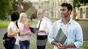 Mixed-race male student looking into distance, higher education and future