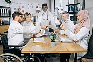 Mixed race medical workers having meeting at office