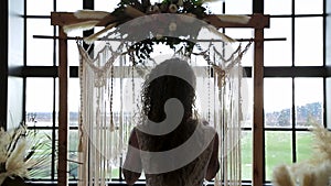 Mixed race modern bride silhouetted against a wedding alter. HD 24FPS.
